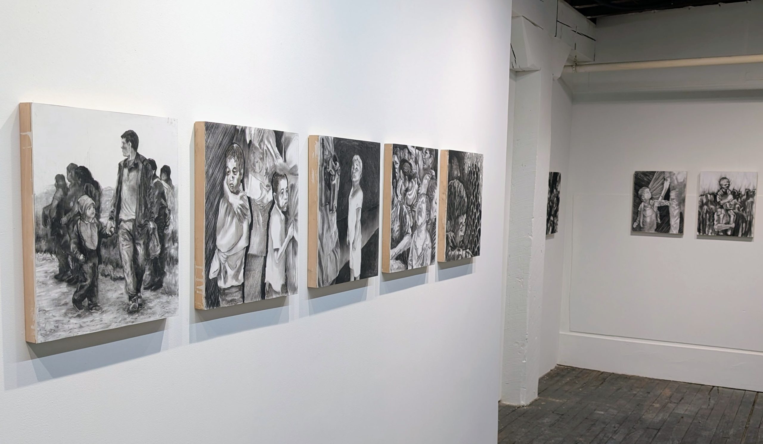 Installation view of Alienation solo exhibition by Juan Diego Gaucin at Gallery Bogart Kansas City, featuring figurative black and white mixed media paintings on wood panels