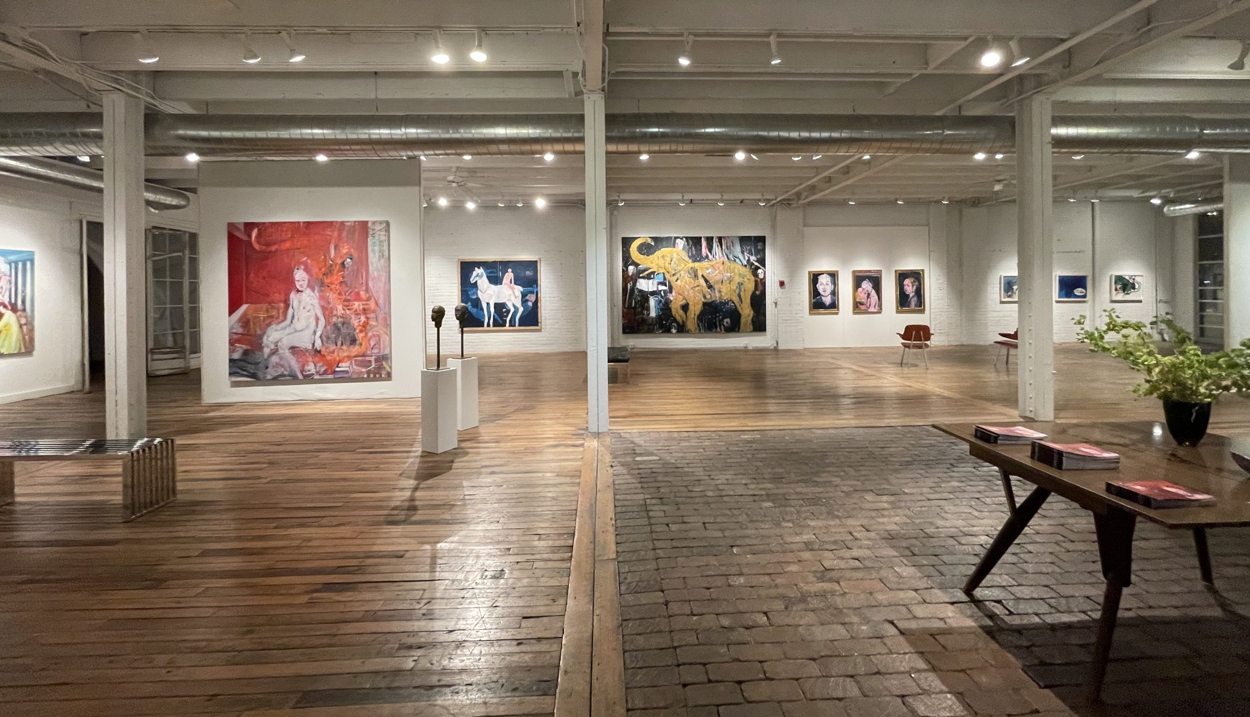 Installation view of In the Middle solo exhibition by renowned Cuban artist Carlos Quintana at Gallery Bogart Kansas City, featuring vibrant large-scale figurative and abstract paintings