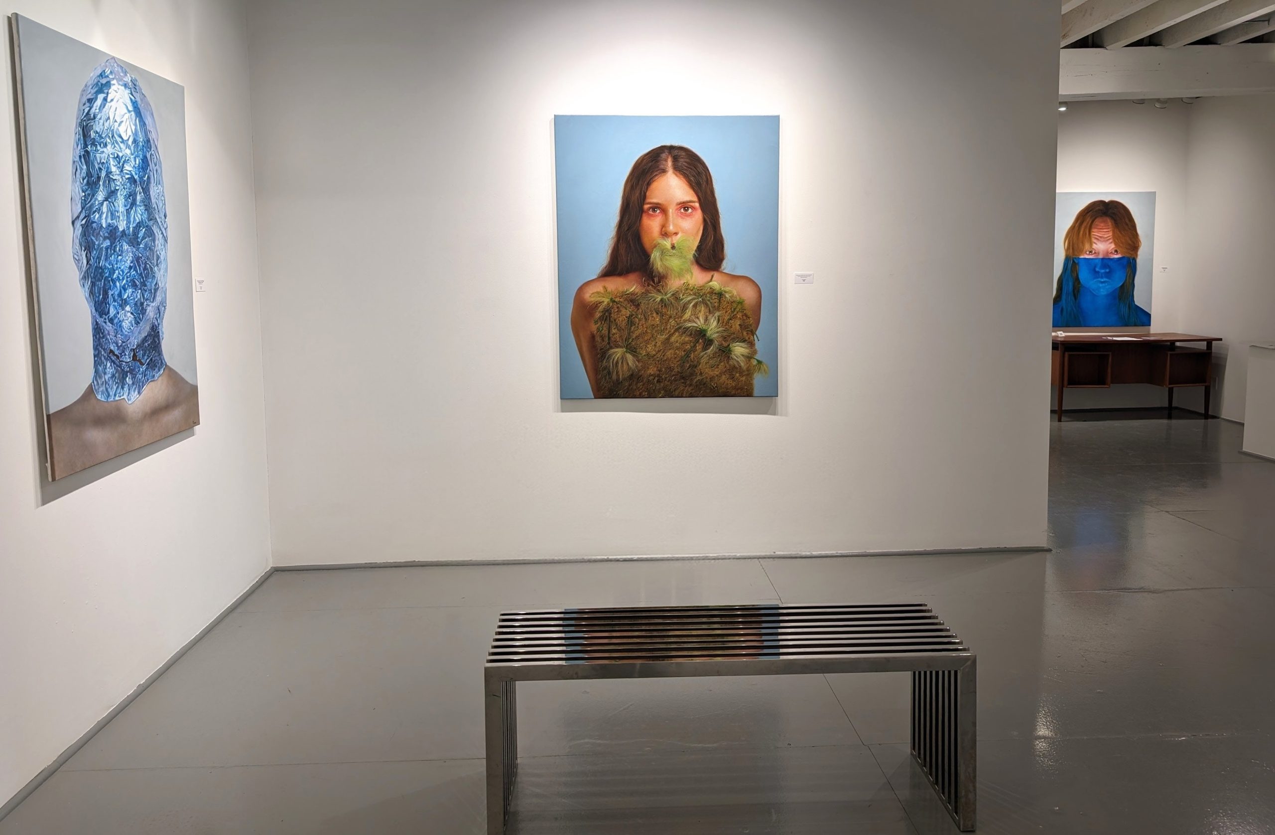 Installation view of Project: ID (Proyecto: ID) solo exhibition by Cuban artist Abel Monagas Alfonso at Gallery Bogart Kansas City, featuring hyperrealistic portraits exploring identity and the human condition.